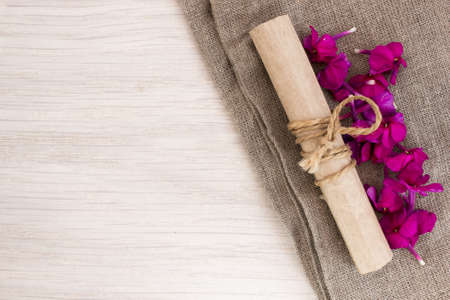 Old scroll on burlap on the tableの写真素材