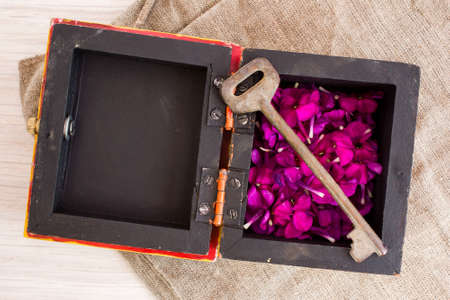 Old key on burlap on the tableの写真素材