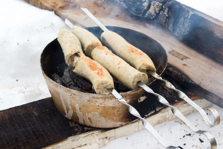 Grilled sausages fried on fireの写真素材