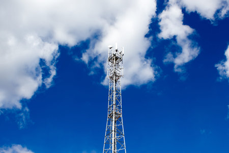 Metal cell phone tower on blue sky backgroundの写真素材