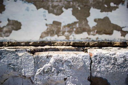 Old concrete wall with a broken plasterの写真素材