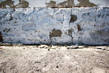 Old concrete wall with a broken plasterの写真素材