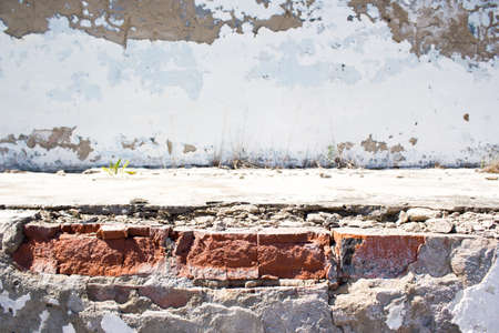 Old concrete wall with a broken plasterの写真素材