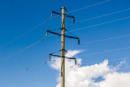 Pole lines on a background of clouds and blue skyの写真素材