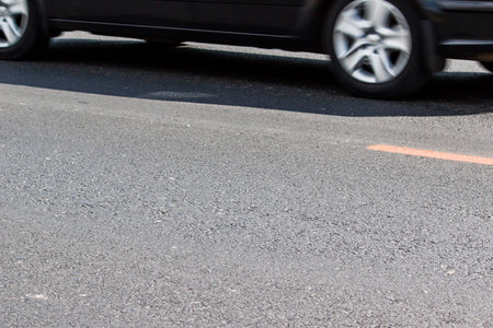 Gray asphalt closeup of the movement of the car