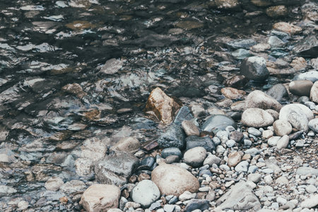 Sand and pebbles. Wave on a river, the sea.