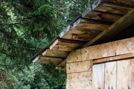 The tourist part of the roof of a wooden house in the summer forestの写真素材