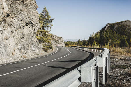 Asphalt road in the mountains a Sunny dayの写真素材