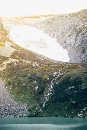 The peak view from the shore of a mountain lake. Journey through the hill country. Tourist attractions, natural beauty.の写真素材