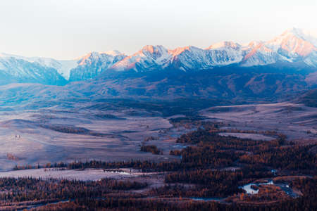 The views of the snowy peaks and the river valley at dawn. Journey through the hill country. Tourist attractions, natural beauty.の写真素材