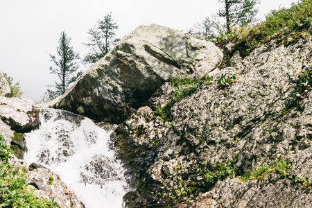 Mountain waterfall in the rocks. Mountain stream, adventure in the mountains.の写真素材
