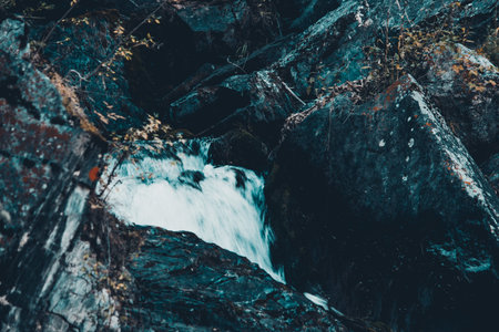 Mountain waterfall in the rocks. Mountain stream, the freshness of the rocks.