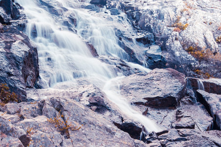 Mountain waterfall on a summer day