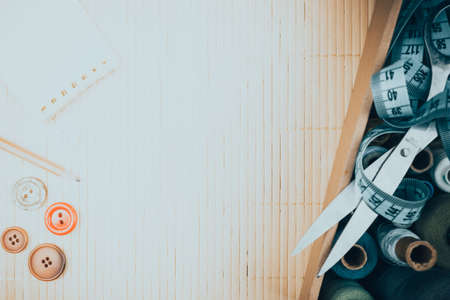 Hanks thread, steel scissors and centimeter for sewing as background. Needlework, tailor hobby.の写真素材