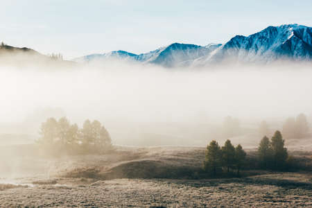 Fog in the mountain valley. Morning fog over the lake in the Altai mountains.の写真素材