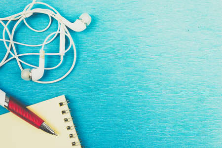 White headphones and wires on blue background. Copy space for text.の写真素材