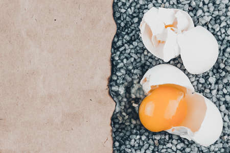 Broken egg on gray gravel, asphalt.の写真素材