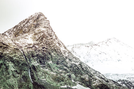 The peak of the mountain rocks in the sky. Mountain climbing, adventure in the mountains.