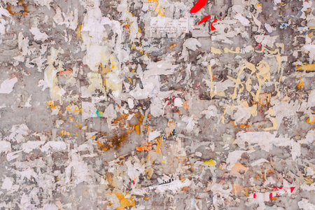 Old wall with remains of paper ads as background