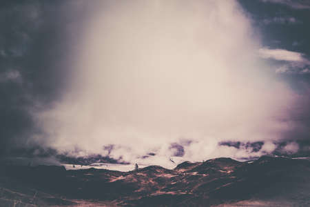 Mysterious view of the hills and canyons in a colorful tone. Mountain peaks in the fog, pastel color.の写真素材