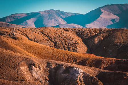 Colored mountains under the blue sky. Red hills of Kyzyl-Chin, Altai. Martian landscape. Red canyon.の写真素材