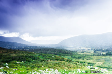 Colorful gentle hills in the cloudy sky.の写真素材