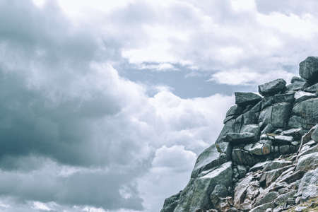 Mountain range under the clouds, rocky peaks and hills under a blue skyの写真素材