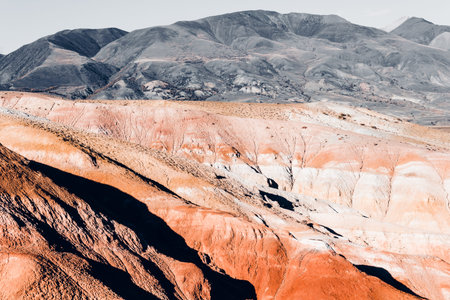Colorful pink hills under the Sunny sky. Rocks and mountains of pastel colours.