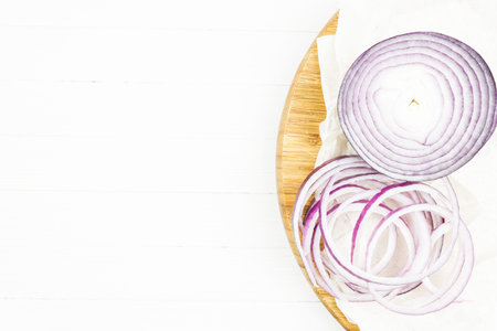 Cut in rings, slices of purple onion. Fresh red onion. Copy space for textの写真素材