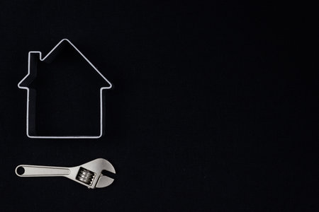 wrench and a symbol of the house. Home repair, plumbing work. Copy space for text