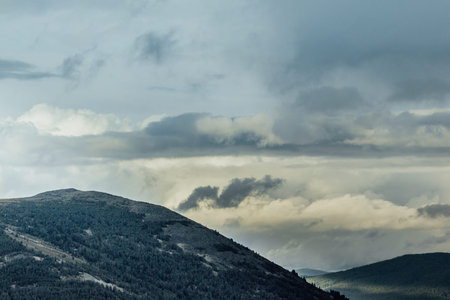 Colorful gentle hills in the cloudy sky.