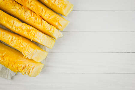 Pieces of fresh pumpkin on a white wooden table.  Copy space for textの写真素材