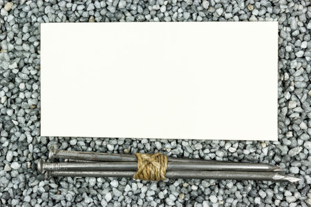 Bunch of nails on gray gravel. Copy space for textの写真素材