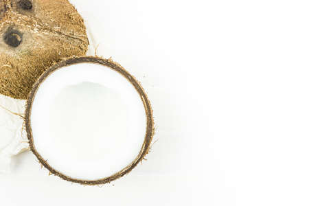 Half of the coconut on a white tableの写真素材