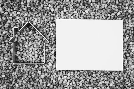 Symbol of the house on gray gravel. Copy space for textの写真素材