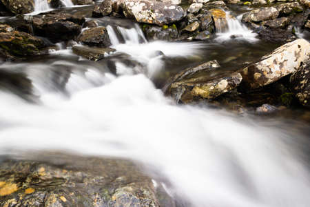 Waterfall in mountains. Rapid flow in river. Water in rocks, trip along river.の写真素材