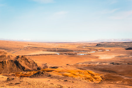 Steppe plain with yellow sand. Yellow soil under hot sun. Mountain empty valley. Travel Altai.