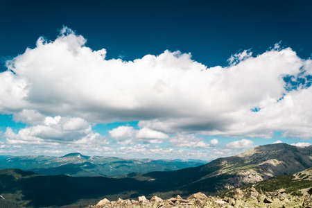 Rocks under blue sky with clouds. View of mountain valley. Tourism, travel to mountains.の写真素材