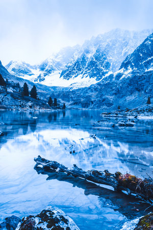 Mountain lake, rocks are reflected in water surface