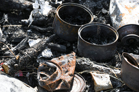 Iron cans burned in fire. Bad ecology, pollution of environment. Nature protection.の写真素材