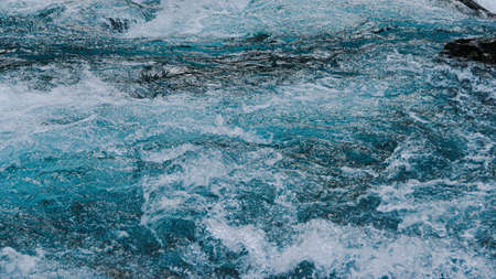 Blue bubbling water of mountain river. Ocean tide of  turquoise seaの写真素材