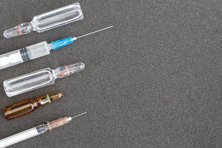 Syringes and vials of medicine on pavement. Hospital treatment. Medicine with liquid injections