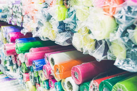 Rolls of colored wrapping paper on counter of store. Holiday and scrapbooking goodsの写真素材