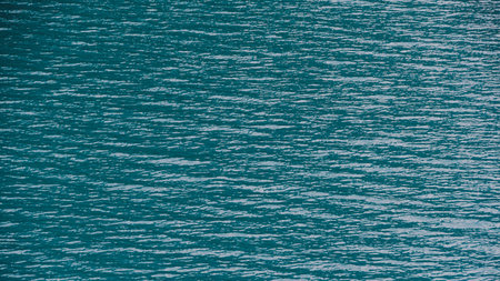 Smooth surface of lake with blue water, turquoise sea as background