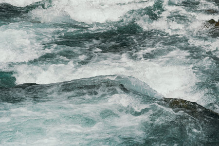 Blue bubbling water of mountain river. Ocean tide of  turquoise sea
