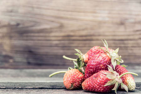 Strawberry berry on wooden table. Fresh berries for summer diet.の写真素材