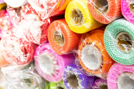 Rolls of colored wrapping paper on counter of store. Holiday and scrapbooking goods