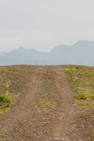 Dirt road in autumn field. Travel through countryside off roadの写真素材