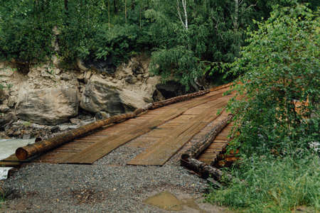 Bridge of logs and sleepers. Wooden flooring for transportation. Ecological road without asphaltの写真素材