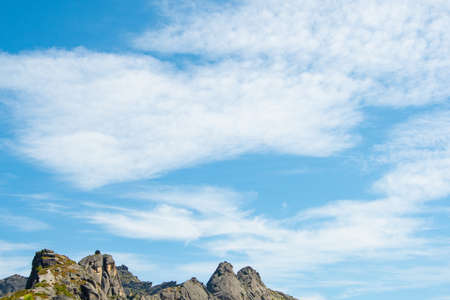 rock ridge under blue cloudy sky, mountain tourism, tourist area for relaxationの写真素材
